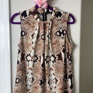 Sleeveless snake pattern blouse.